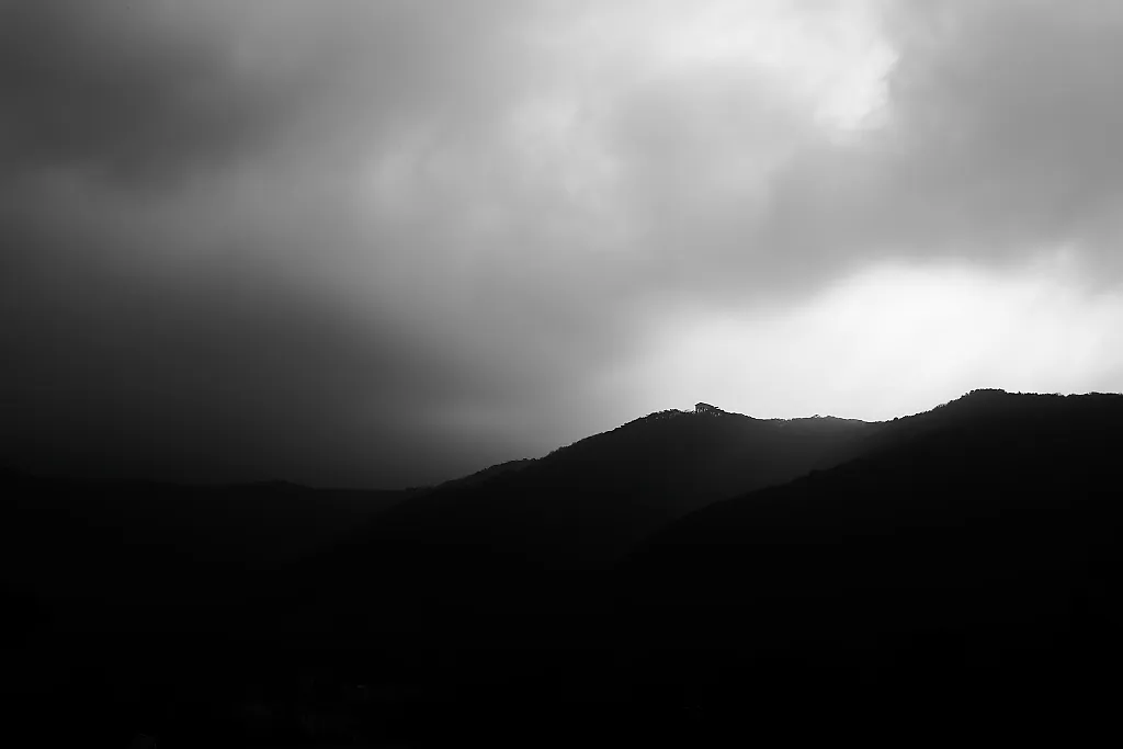 temple on forested hills with strong backlight